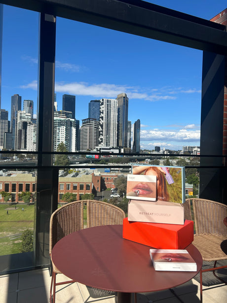 Packaging boxes on top of table with a background view of skyscraper buildings  