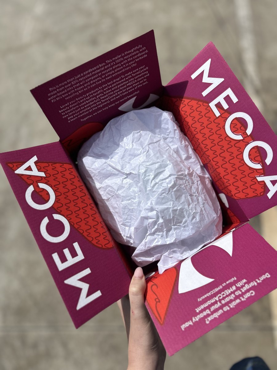 Customer opening a custom branded Mecca box